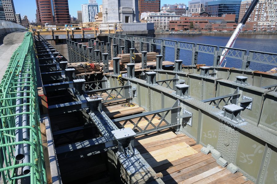 New steel floor beams on the Longfellow Bridge deck, with the Boston skyline behind