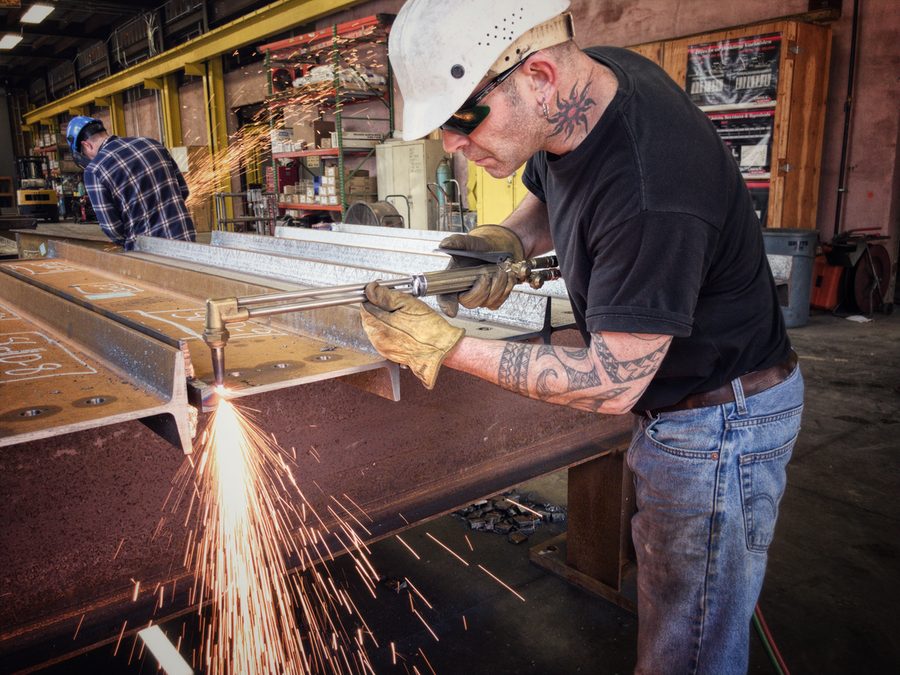 A fabricator cutting a steel plate in the shop